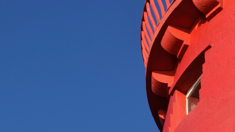 A close-up photograph of the side of the top of the red-coloured Poolbeg lighthouse in Dublin.