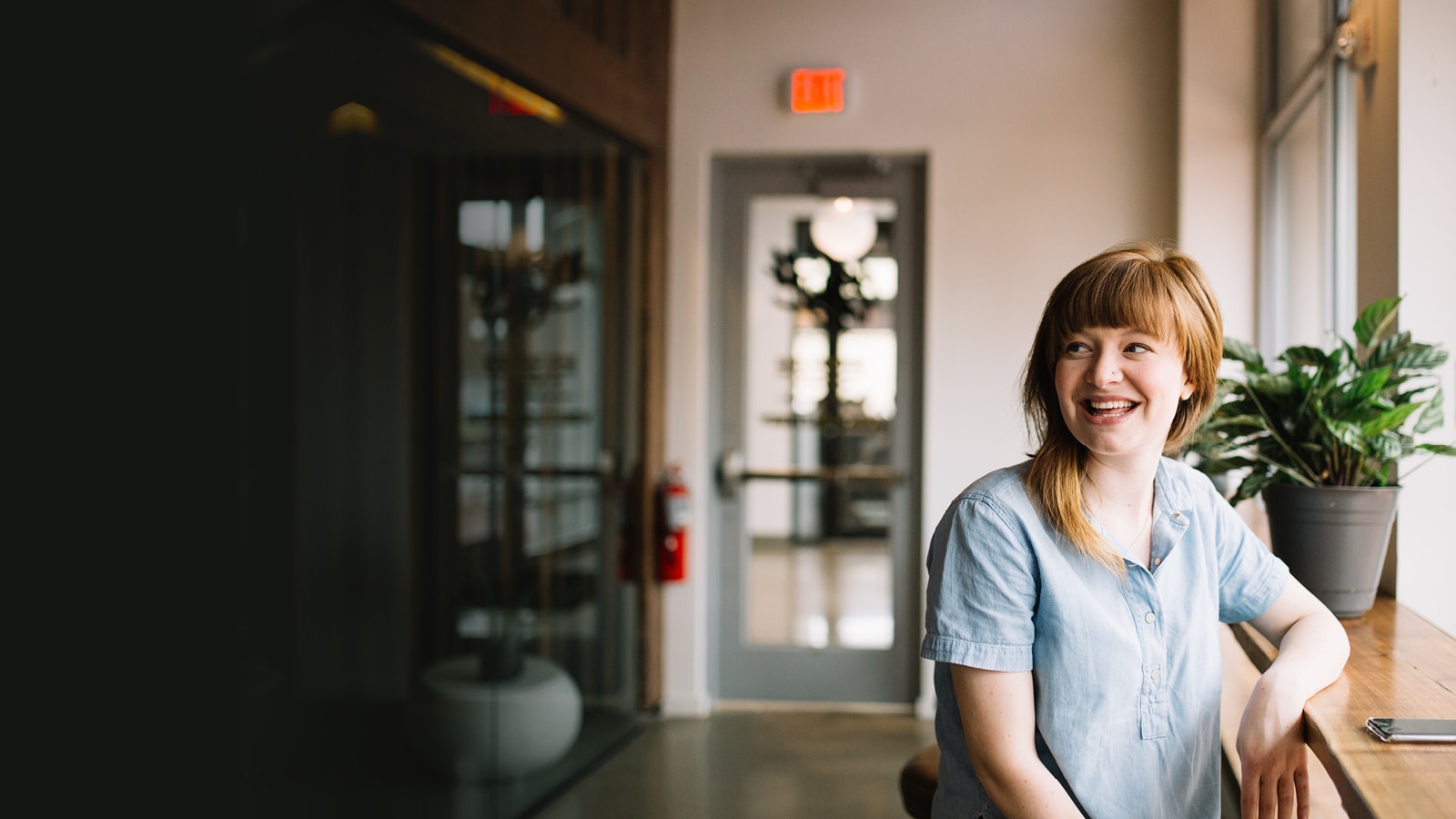 A woman sitting in a reception area. 