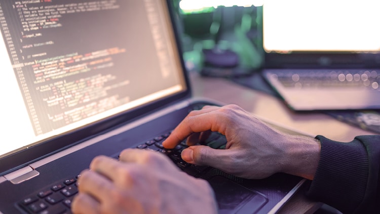 A person typing code.