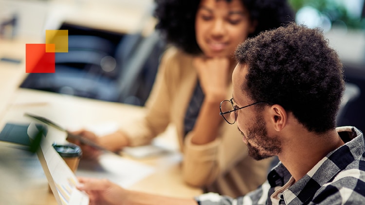 Two business professionals reviewing a document.