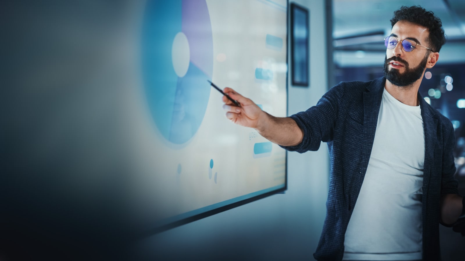 A Business professional presenting a data visualisation in a meeting.