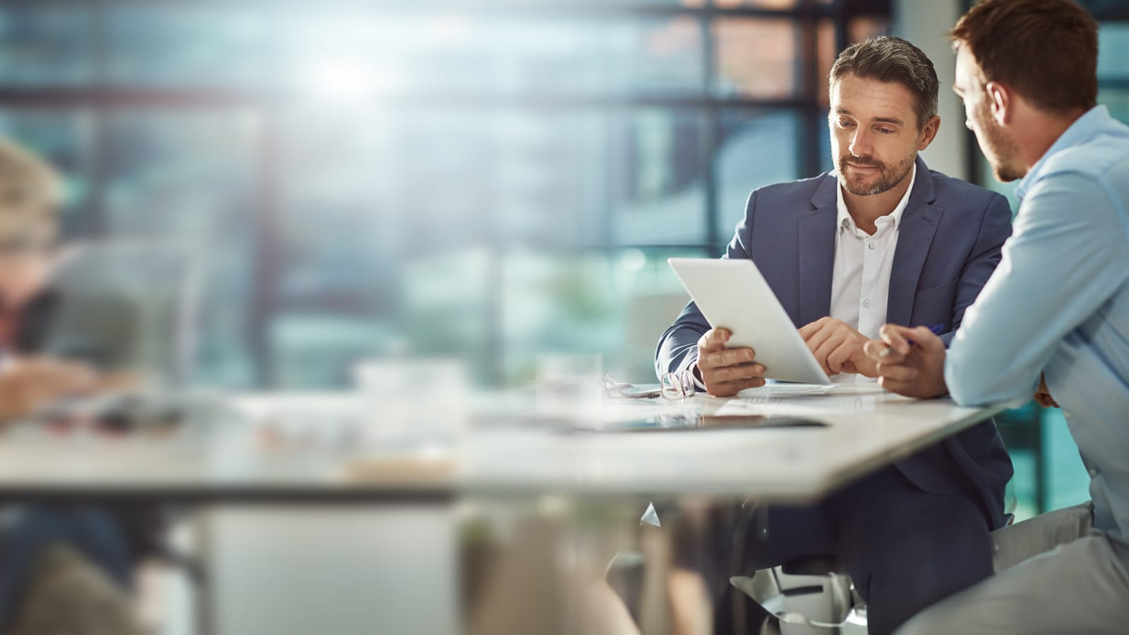 two men working together in an office