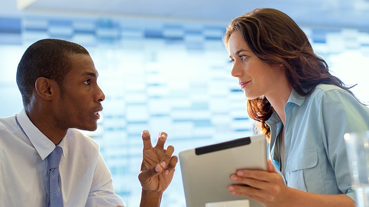 Two people discussing a file
