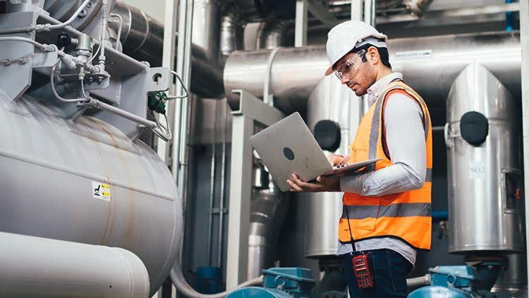 An engineer looking at a laptop