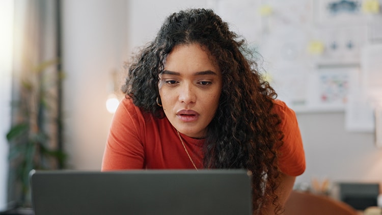 A woman looking at a computer screen