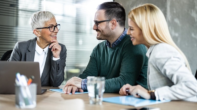 A couple talking to an agent