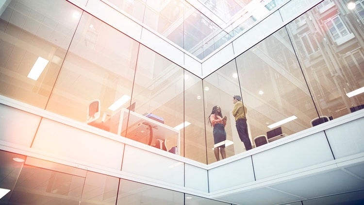 People in an upstairs office walkway