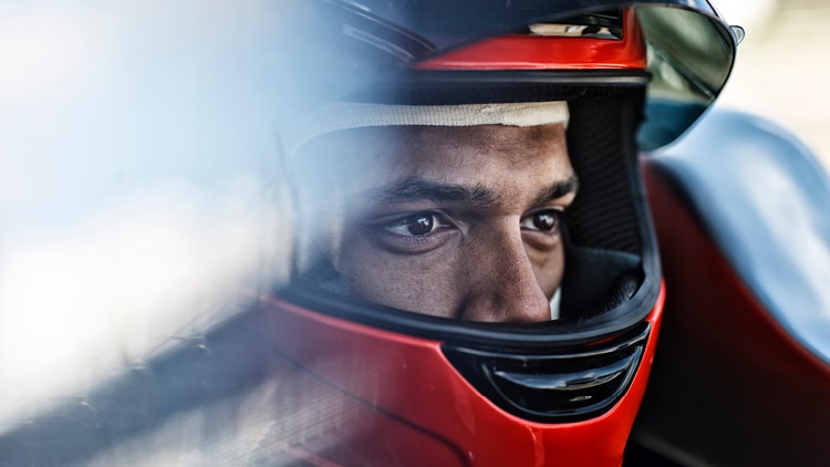 A man in a car racing helmet
